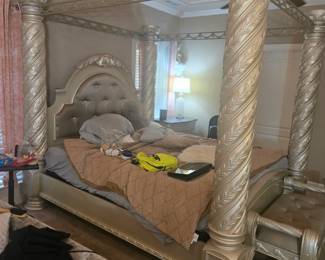 King Canopy Bed – Four-poster design with spiral-carved columns, tufted upholstered headboard, and ornate crown molding. Approx. 86” H x 82” W x 88” L.