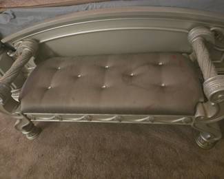 Upholstered bench with carved wood scroll arms, perfect at the foot of the bed. Approx. 48” W x 18” D x 22” H.