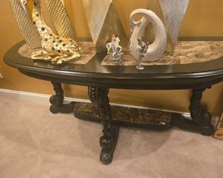 Elegant traditional console table with rich black carved wood and a genuine marble top. Features ornate curved legs, lower marble shelf for display or storage, and a smooth polished finish. Perfect for an entryway or formal living area. Dimensions (approx.): 48" W × 16" D × 32" H.