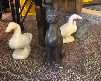 Bronze cat and marble ducks