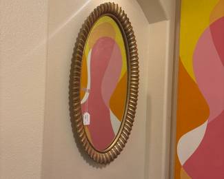 Round gold framed mirror