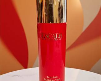 Vintage Escada Margaretha Ley “Talc Soie” silkening talc powder. Iconic red and gold packaging with a metallic cap. Hard-to-find beauty item from Escada’s classic fragrance line. Container appears lightly used and well preserved. 