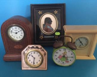 Small clocks and reverse painted silhouette