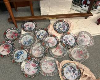 An entire collection of Lena Liu hummingbird plates with the rack.