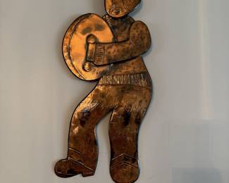 Set of copper wall hanging of a person playing a bodhrán, an Irish frame drum