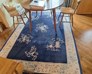 Vintage solid wood dining table. Woven rug.