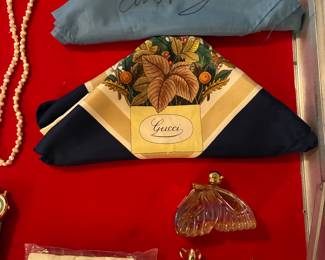 Elvis Presley souvenir scarf, Gucci silk scarf, collectible perfume bottles from Avon- Sweet Honesty Butterfly, Peek a Mouse cologne, and Regence cologne