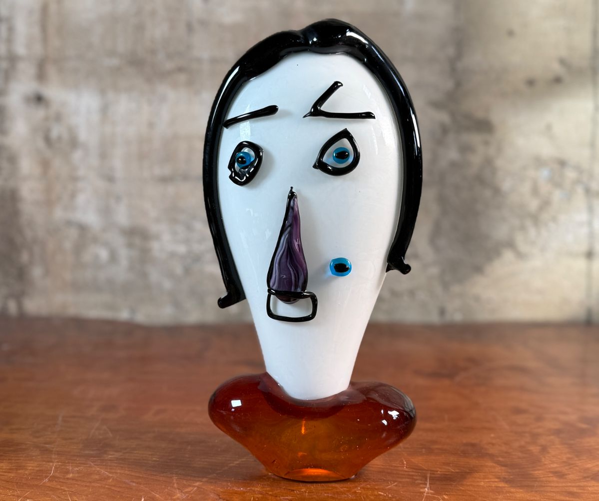 This lot features an Italian Murano glass face sculpture, circa 1970s. This sculpture is in good overall condition and measures, 14” H x 7” W x 3.5” D.
