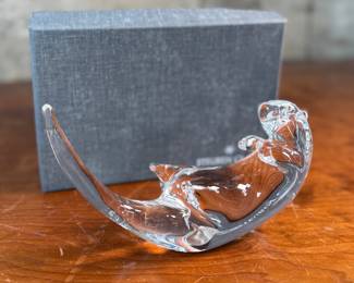 This lot features a Steuben Crystal Glass sea otter figurine, designed by James Houston in 1978. Comes with a Steuben box for storage.
