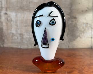 This lot features an Italian Murano glass face sculpture, circa 1970s. This sculpture is in good overall condition and measures, 14” H x 7” W x 3.5” D.
