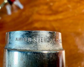 This lot features an antique sterling silver thread holder, manufactured and signed by Napier. The sterling case alone weighs approx. 19.53 grams.
