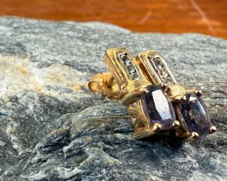 This lot features a pair of 10k gold earrings, each with a few diamonds and a sapphire center stone. This pair has a total approx. weight of 2.30 grams.
