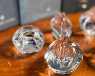This lot features a collection of five (5) animal themed Steuben Glass sculptures, with five cases to accompany them. Steuben Glass is an American art glass company founded in Corning, New York, in 1903 by Frederick Carder. Originally known for colored glass, it shifted to brilliant clear crystal in the 1930s after being acquired by Corning Glass Works (now Corning Inc.) in 1918. The brand was sold in 2008, production ceased in 2011, and was reacquired by Corning Inc., which now oversees its production and sales through the Corning Museum of Glass.
