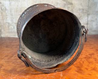 This lot features an antique etched copper cauldron, likely Turkish and from the 19th century. This piece measures, 9” H x 10” W x 10” D.
