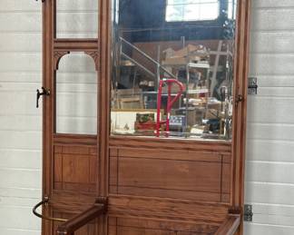 A stunning antique hall tree with solid brass hardware, a single dove tailed drawer below the bench, and an umbrella holder. This piece is in very good condition for its age and measures, 85” H x 36” W x 21” D.
