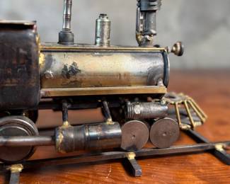 This lot features a unique handcrafted locomotive sculpture made of various metals and salvaged materials. It has a brass plaque mounted on top from Jacksonville, Oregon. This sculpture measures, 6” H x 13” W x 5” D.
