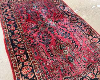 This lot features an antique handwoven Sarouk rug that measures, 74” H x 48” W.
