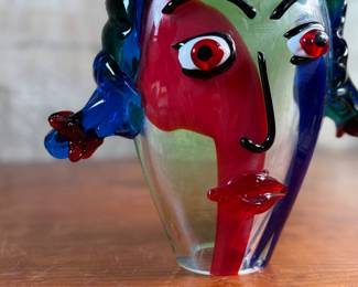 This lot features an Italian Murano glass face sculpture, circa 1970s. This sculpture is in good overall condition and measures, 10.5” H x 11.5” W x 3.5” D. There is a small chip on the lower base shown in photos that is hardly noticeable.
