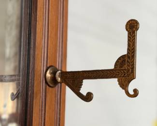 A stunning antique hall tree with solid brass hardware, a single dove tailed drawer below the bench, and an umbrella holder. This piece is in very good condition for its age and measures, 85” H x 36” W x 21” D.
