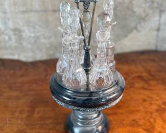 This lot features an antique cruet that appears to be made in the 19th century with five (5) misc. bottles, all of which appear to be cut crystal glass. This cruet measures, 18” H x 8” W x 8” D.
