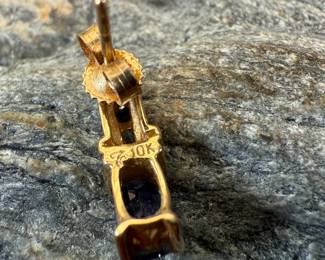 This lot features a pair of 10k gold earrings, each with a few diamonds and a sapphire center stone. This pair has a total approx. weight of 2.30 grams.
