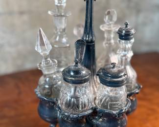 This lot features an antique Meriden Brittania cruet, with maker marks underneath as shown in photos. This cruet has seven (7) misc. containers included, some of which appear to have silver accents. Measures, 18” H x 8” W x 8” D.

