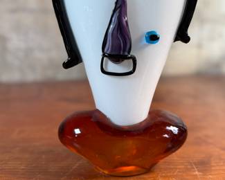 This lot features an Italian Murano glass face sculpture, circa 1970s. This sculpture is in good overall condition and measures, 14” H x 7” W x 3.5” D.
