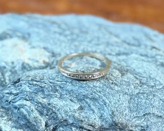 This lot features a 14k gold band with diamonds in a size 8.5 with a total approx. weight of 1.63 grams.
