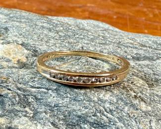This lot features a 14k gold band with diamonds in a size 8.5 with a total approx. weight of 1.63 grams.
