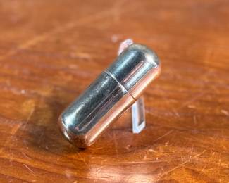 This lot features an antique sterling silver thread holder, manufactured and signed by Napier. The sterling case alone weighs approx. 19.53 grams.
