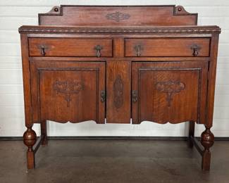 This lot features an antique Quarter-Sawn Oak sideboard with two dove tailed drawers and two cabinets with shelving. Minor wear throughout, but in good overall condition and measures, 42.5” H x 47.5” W x 17.25” D.
