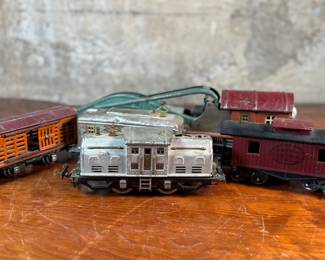 This lot features a collection of five (5) pre-war model train cars, manufactured by Lionel and all most likely O gauge. Includes a locomotive, a box car, a few cabooses, and more.
