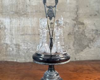 This lot features an antique cruet that appears to be made in the 19th century with five (5) misc. bottles, all of which appear to be cut crystal glass. This cruet measures, 18” H x 8” W x 8” D.
