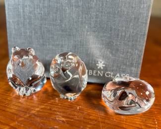 This lot features a collection of five (5) animal themed Steuben Glass sculptures, with five cases to accompany them. Steuben Glass is an American art glass company founded in Corning, New York, in 1903 by Frederick Carder. Originally known for colored glass, it shifted to brilliant clear crystal in the 1930s after being acquired by Corning Glass Works (now Corning Inc.) in 1918. The brand was sold in 2008, production ceased in 2011, and was reacquired by Corning Inc., which now oversees its production and sales through the Corning Museum of Glass.
