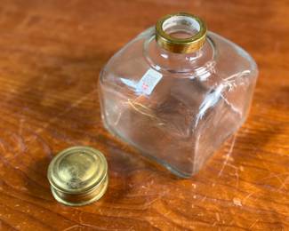 This lot features a vintage glass storage jar, manufactured by Danish company, Holmegaard. In good overall condition with maker sticker present as shown in photos. Holmegaard is a historic Danish glassworks, founded in 1825 by Countess Henriette Danneskiold-Samsøe, that is known for its artistic and functional design. The brand, now owned by the Rosendahl Design Group, continues a tradition of Danish glassmaking that has included prominent designers like Jacob E. Bang, Per Lütken, and Jette Frölich. Today, Holmegaard continues to produce designs rooted in Scandinavian modernism and craftsmanship.
