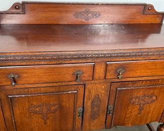 This lot features an antique Quarter-Sawn Oak sideboard with two dove tailed drawers and two cabinets with shelving. Minor wear throughout, but in good overall condition and measures, 42.5” H x 47.5” W x 17.25” D.
