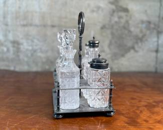 This lot features an antique cruet that appears to be made in the 19th century with six (6) misc. bottles, three of which appear to have silver accents to them. This cruet measures, 10” H x 7.5” W x 5.5” D.
