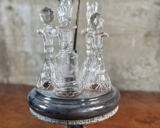 This lot features an antique cruet that appears to be made in the 19th century with five (5) misc. bottles, all of which appear to be cut crystal glass. This cruet measures, 18” H x 8” W x 8” D.
