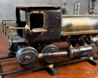 This lot features a unique handcrafted locomotive sculpture made of various metals and salvaged materials. It has a brass plaque mounted on top from Jacksonville, Oregon. This sculpture measures, 6” H x 13” W x 5” D.
