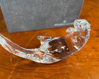 This lot features a Steuben Crystal Glass sea otter figurine, designed by James Houston in 1978. Comes with a Steuben box for storage.
