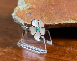 This lot features a vintage set of Zuni Native American jewelry including a bracelet cuff, earrings, and a ring made of sterling silver. The cuff has one inlay piece missing as shown in photos. The ring is a size 5, and the set has a total approx. weight of 57.05 grams. 
