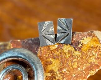 This lot features a collection of modernist sterling silver jewelry including a brooch, a pendant, and a pair of earrings with a total approx. weight of 18.70 grams.
