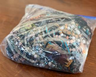 This lot features a large bag full of costume jewelry and weighs just under 4lbs.
