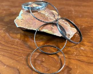 This lot features a collection of five (5) sterling silver bracelets with a total approx. weight of 70.97 grams.

