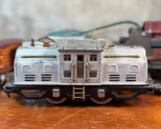 This lot features a collection of five (5) pre-war model train cars, manufactured by Lionel and all most likely O gauge. Includes a locomotive, a box car, a few cabooses, and more.
