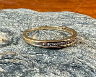This lot features a 14k gold band with diamonds in a size 8.5 with a total approx. weight of 1.63 grams.
