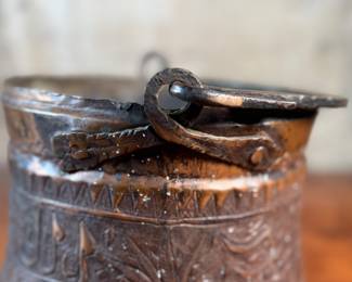This lot features an antique etched copper cauldron, likely Turkish and from the 19th century. This piece measures, 9” H x 10” W x 10” D.
