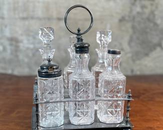 This lot features an antique cruet that appears to be made in the 19th century with six (6) misc. bottles, three of which appear to have silver accents to them. This cruet measures, 10” H x 7.5” W x 5.5” D.
