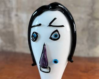This lot features an Italian Murano glass face sculpture, circa 1970s. This sculpture is in good overall condition and measures, 14” H x 7” W x 3.5” D.
