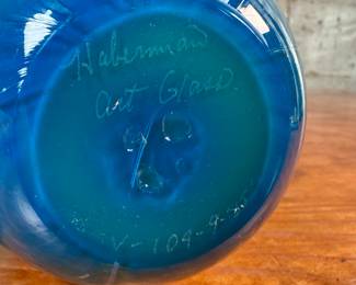 This lot features a stunning vase by Haberman Art Glass, signed underneath as shown in photos, circa 1985. This vase measures, 7” H x 4.5” W x 4.5” D.
